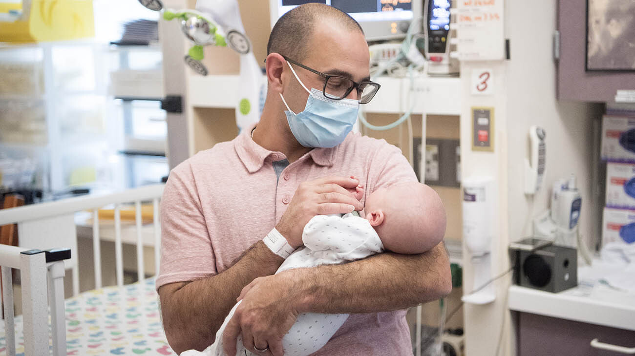 Frank holds Patrick in the NICU shortly before he was discharged from the NICU. (Courtesy: Cleveland Clinic)