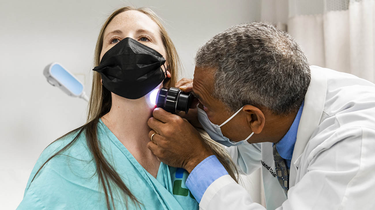 Dr. Philip Bernard checking for cancerous moles during Melissa's exam. 