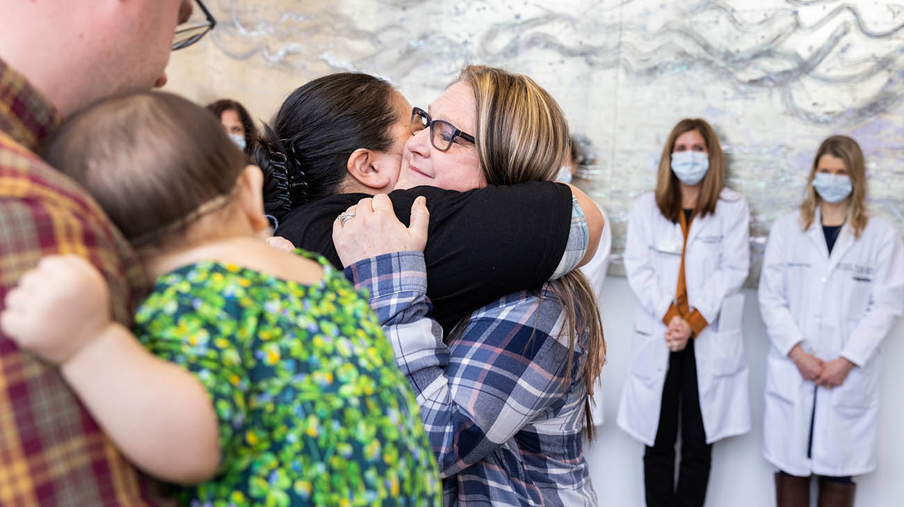 Organ donor Lori Seitz hugs the mother of transplant recipient, Emma Murphy.