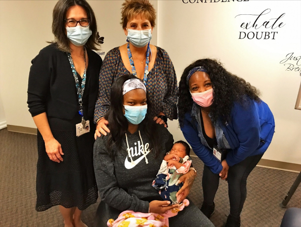 Participating mother and newborn visiting Centering group to share her little girl and delivery experiences with the others in the CenteringPregnancy® group.