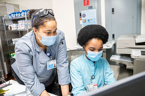 Caregivers looking at a computer