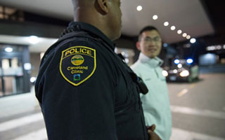 A Cleveland Clinic police officer helping a person.