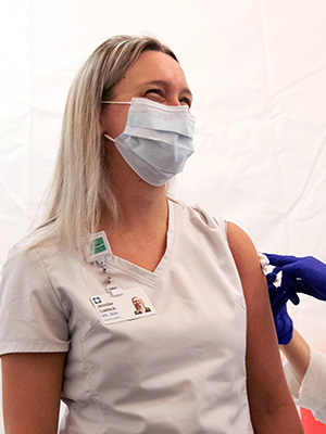 A caregiver receiving a vaccine.