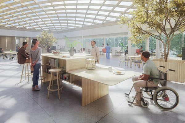 Group of people around a desk in a pavillion with a lot of natural light and greenery