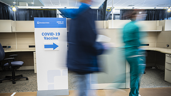 Caregivers blurred in front of covid vaccine clinic entrance