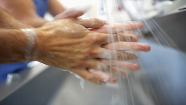 caregiver washing hands in surgery prep