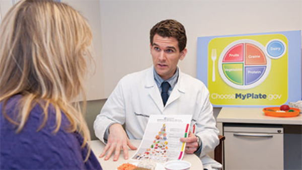 doctor showing a chart to a patient