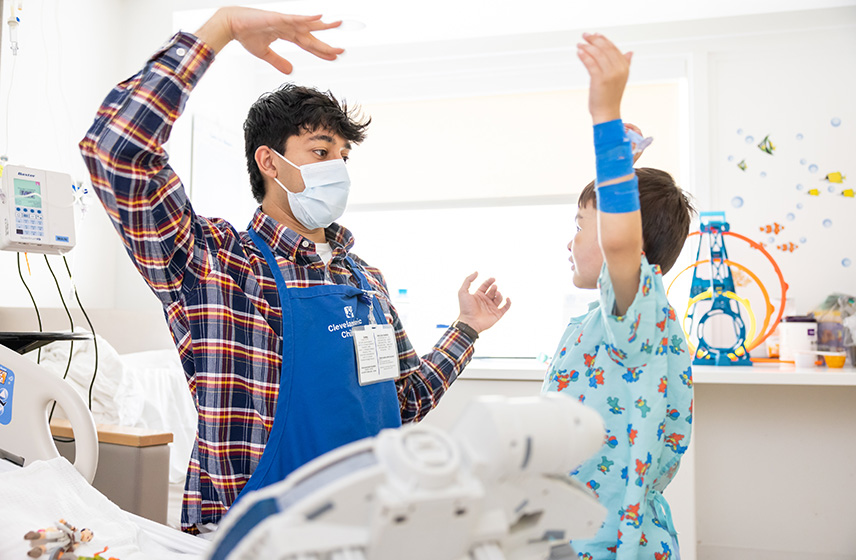 Volunteer visiting with pediatric patient