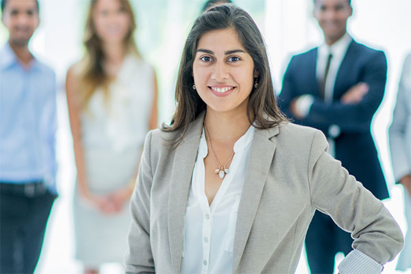 Woman professional amongst a group of healthcare leaders.