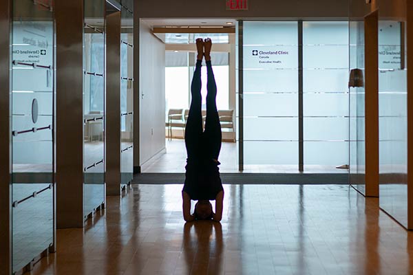 Person doing a handstand in a Cleveland Clinic hallway.