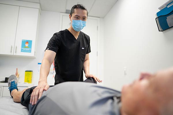 Caregiver working on a patient's leg.