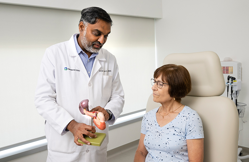 Cleveland Clinic physician with a patient going over information on a model