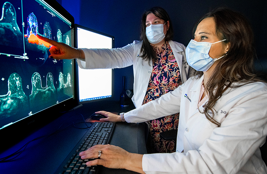 Two Cleveland Clinic caregivers reviewing mammogram scans.