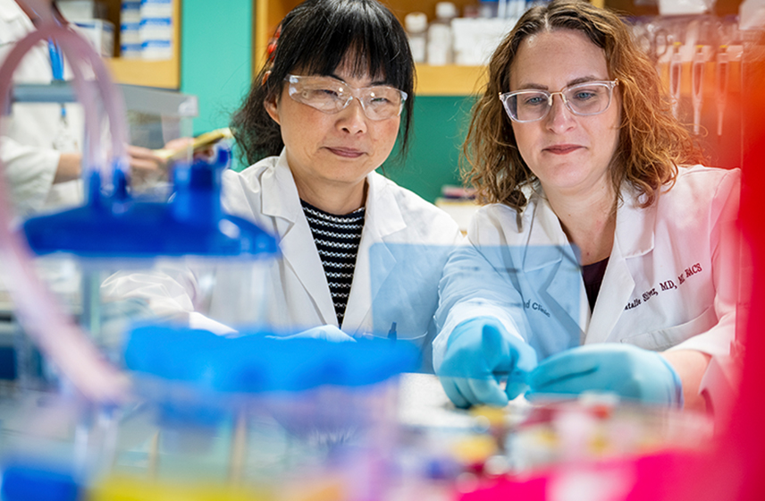 Two Cleveland Clinic caregivers working in a lab.