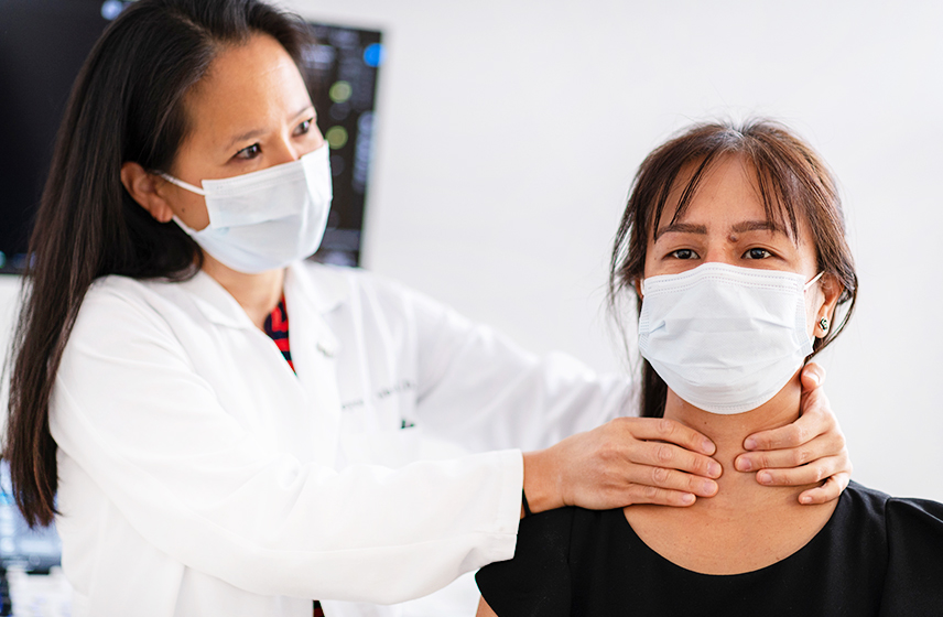 Physician examining a patient's throat.