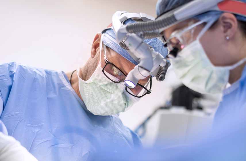 Cleveland Clinic surgeon performing free flap surgery on a patient in the operating room.