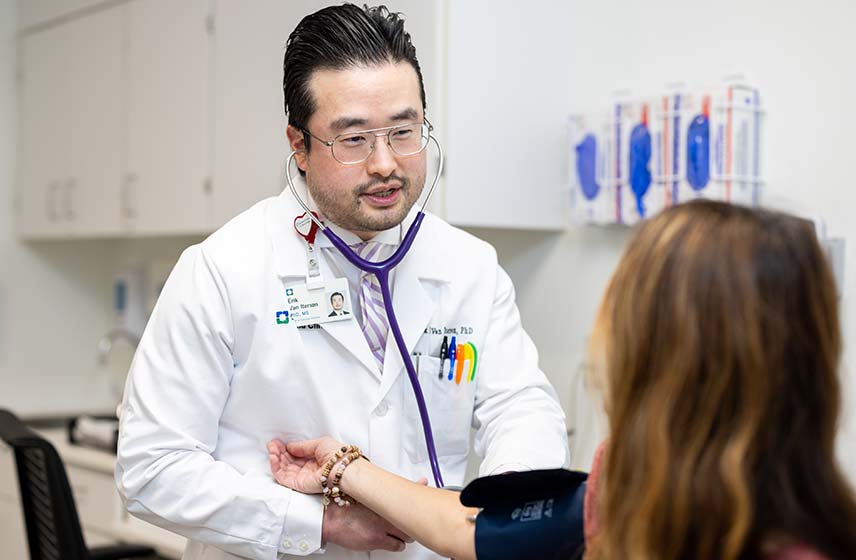 Doctor taking patient's blood pressure | Cleveland Clinic