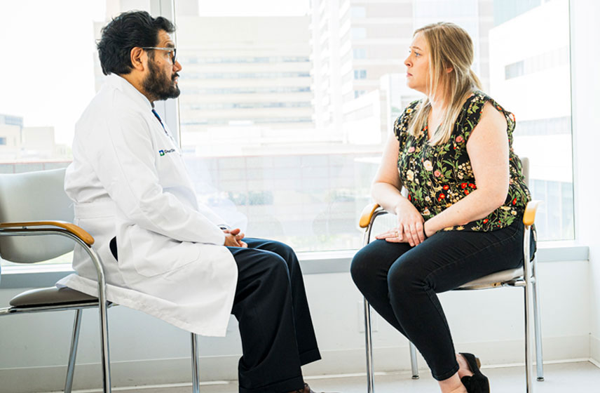 Cleveland Clinic provider consulting a patient in his office.