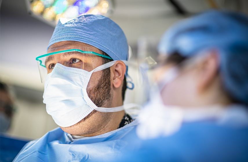 Surgeon with a mask during a procedure.