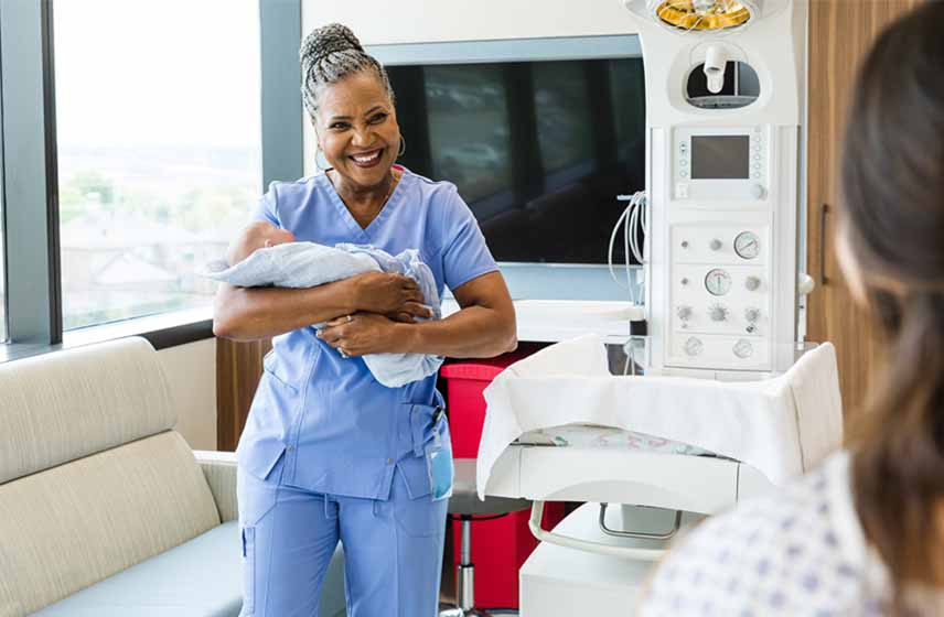 midwife holding a newborn