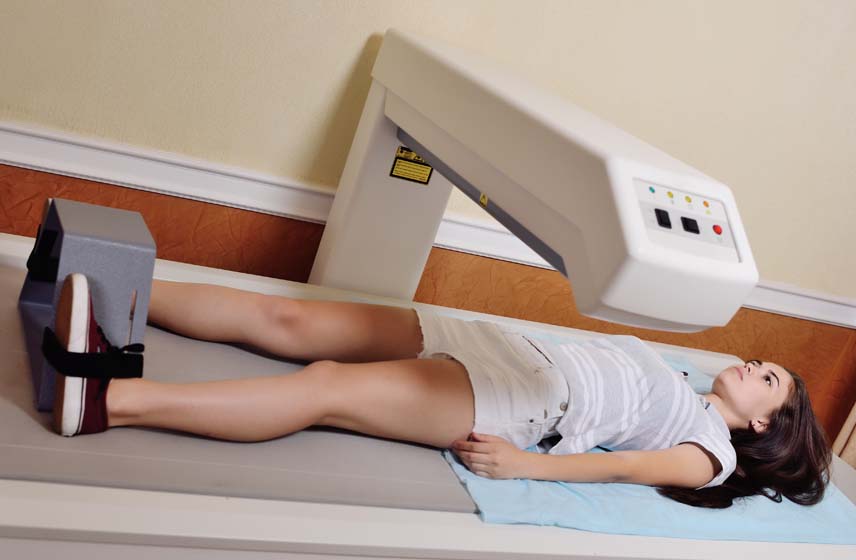 A patient laying under a scanner.