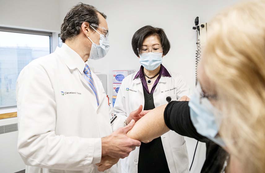 Doctors examining scleroderma patient