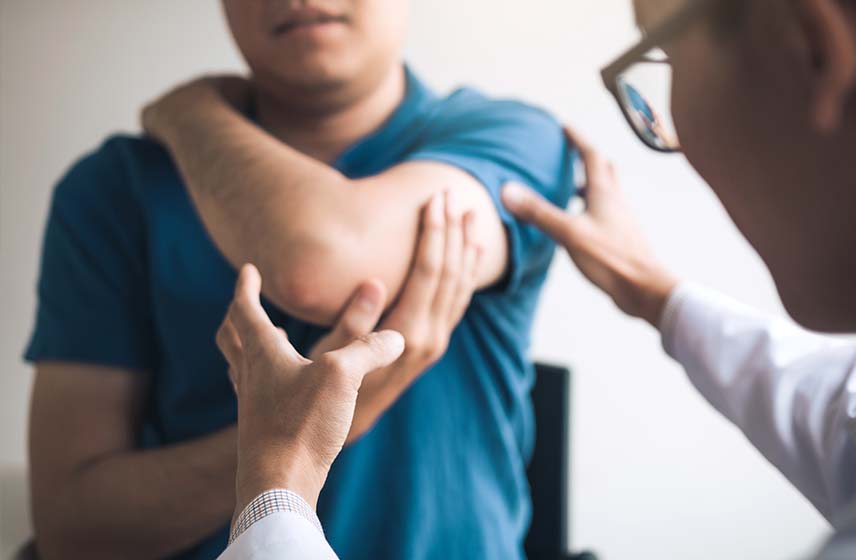 Doctor examining patient with a shoulder labral tear