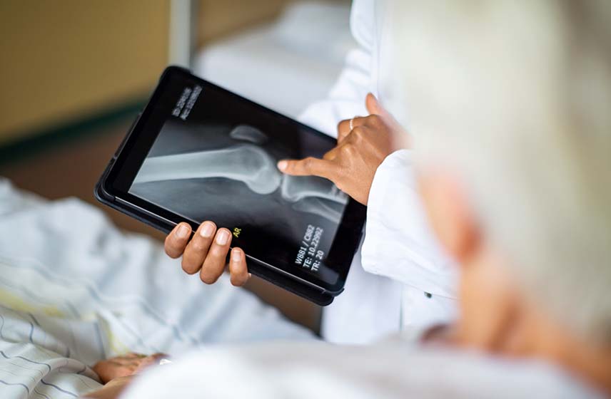 Patient and doctor reviewing knee X-ray