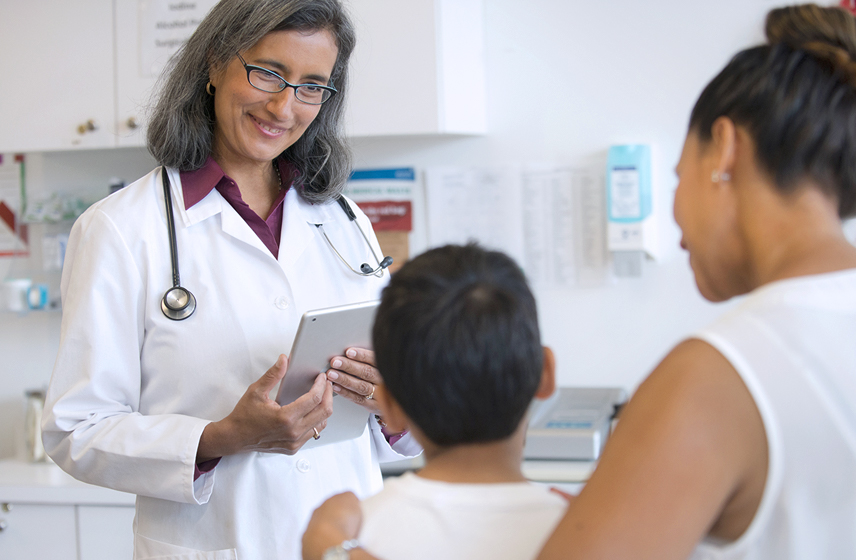 Cleveland Clinic doctor speaking with pediatric patient and their mother.