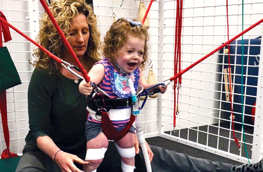 Child with Shwachman-Diamond syndrome actively engaged in physical therapy to help improve mobility.