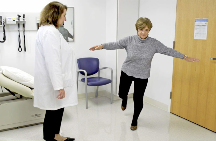 Doctor evaluating a geriatric patient's balance.