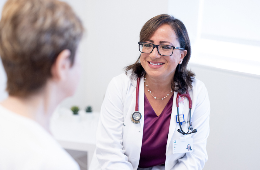 Provider talking to a patient in an exam room.