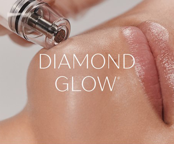 A person applying diamond glow to their face.