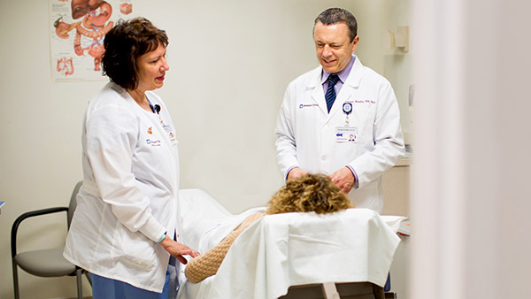 Dr. Kessler and a nurse talking to a patient