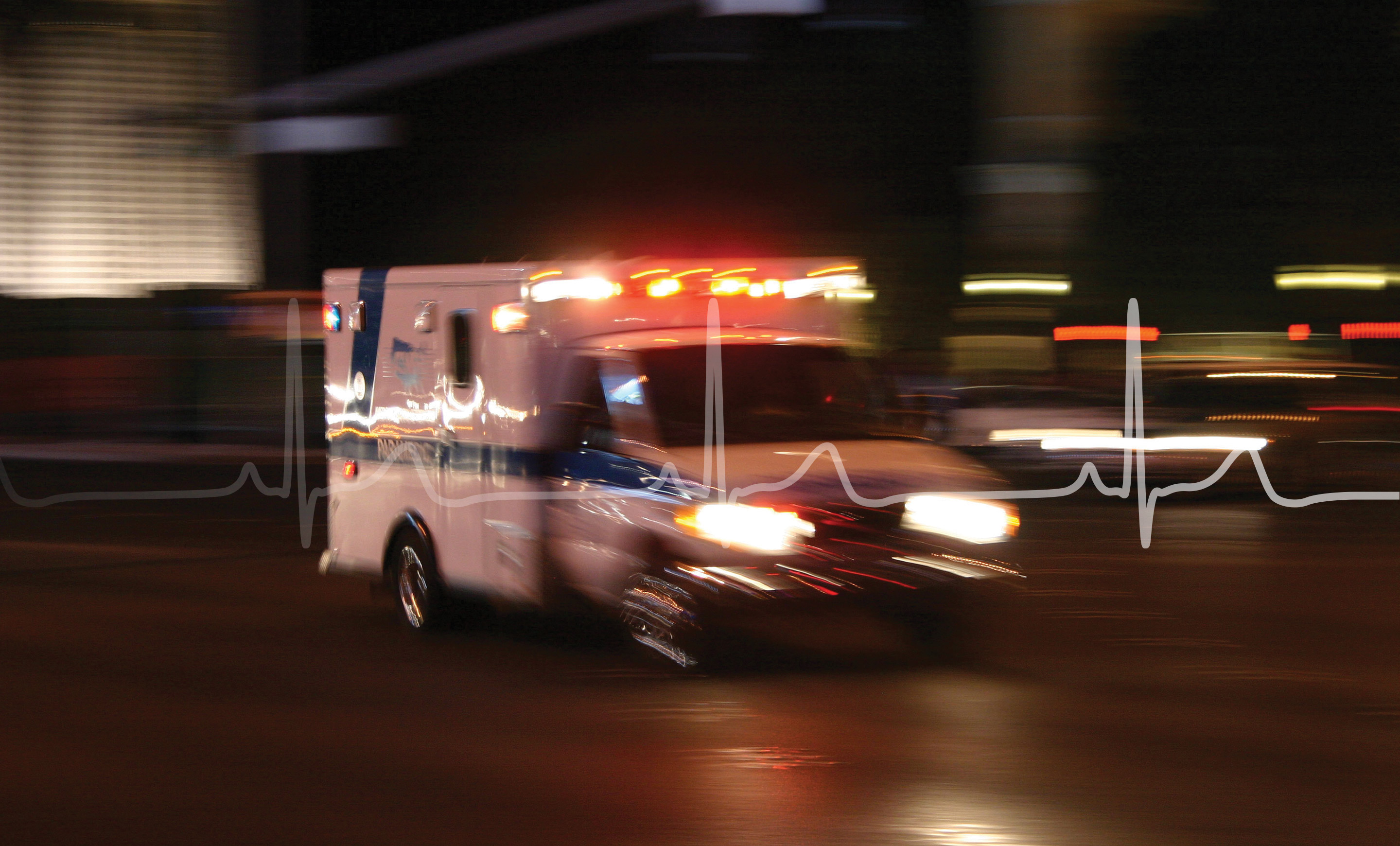Ambulance speeding through a city at night with motion blur and flashing lights, overlaid with an electrocardiogram line.