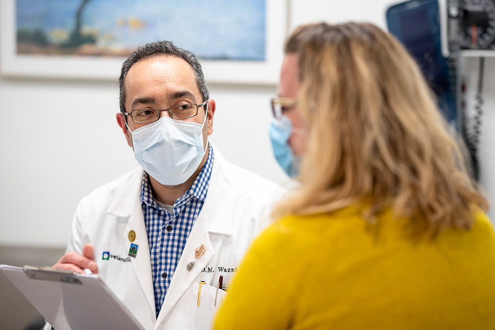 Doctor and employer in masks talking