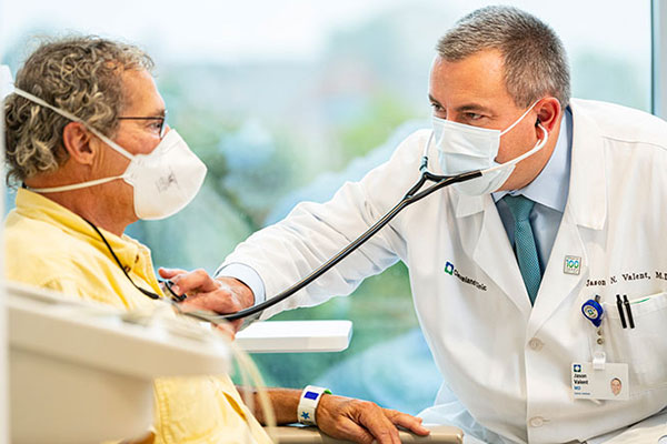 A Cleveland Clinic caregiver listening to a patient's chest.