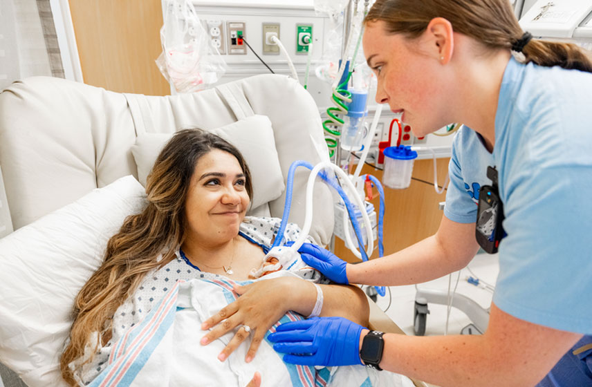 Physician and patient high-fiving in an exam room.