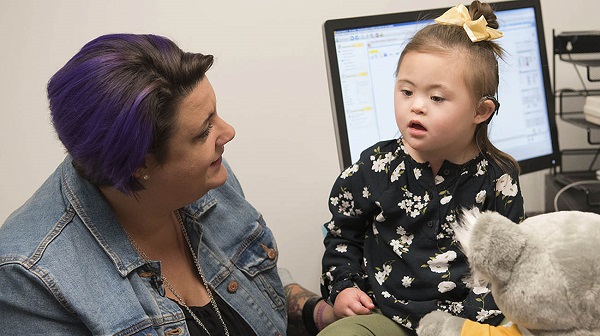 Young patient with Down syndrome in doctor's office