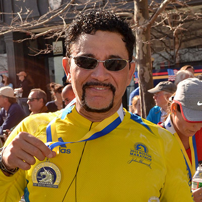 Julio Cruz, MD, displays his medal at the 2014 Boston Marathon