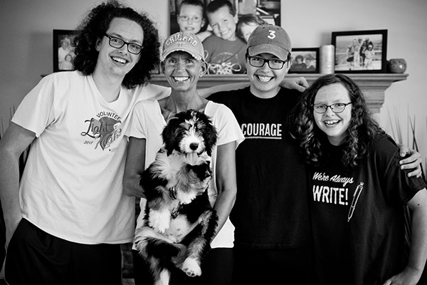 Claire Firrell with her three children and her puppy in 2019