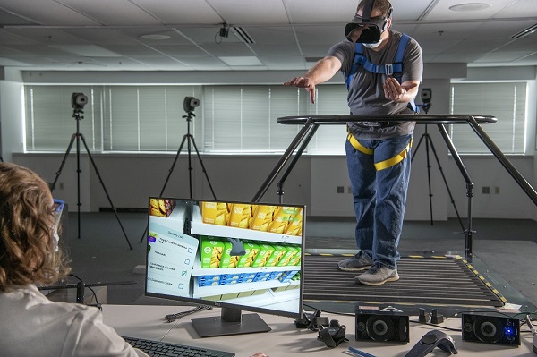 A study volunteer “shops” at a virtual grocery store while on an omnidirectional treadmill.