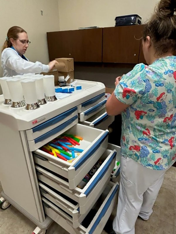 two caregivers with sensory cart