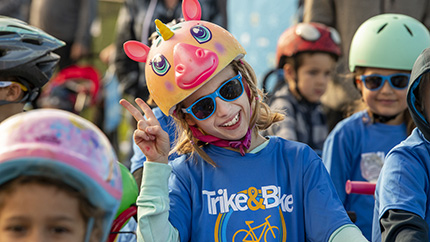 Girl giving peace sign during Trike & Bike