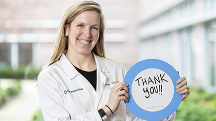 Cleveland Clinic doctor holding thank you sign