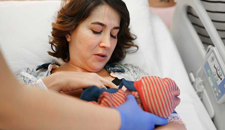 A lactation consultant helping an infant latch