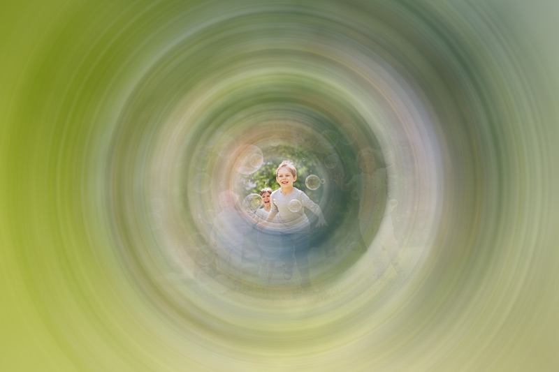 A photo of children playing outside viewed through tunnel vision