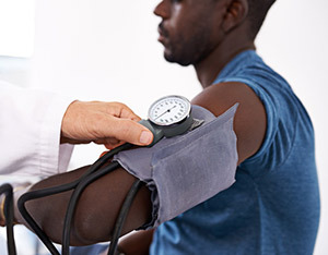 A man getting his blood pressure read by a doctor.