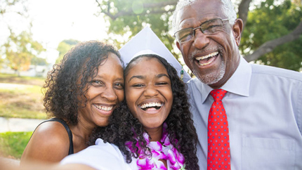 family posing for picture with graduate
