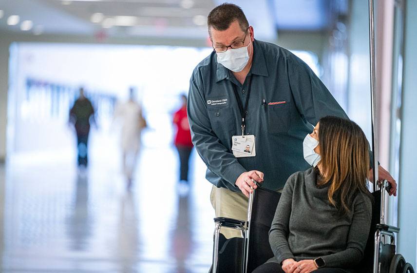 Cleveland Clinic caregiver helping patient in wheelchair